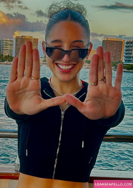 Abella Danger snaps picture by city side in front of lake