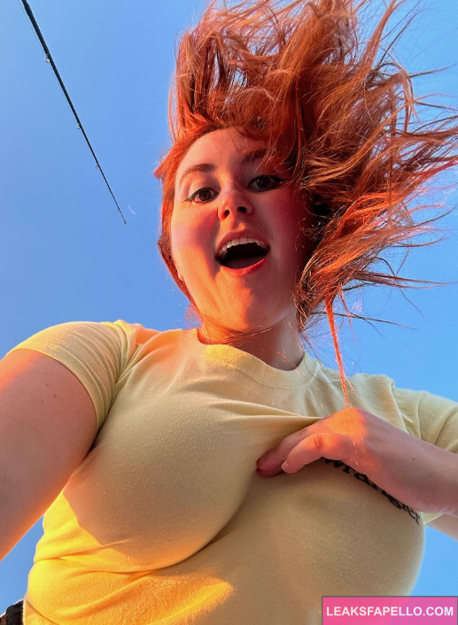 Isla Moon takes a selfie while holding huge boobs in her left hand