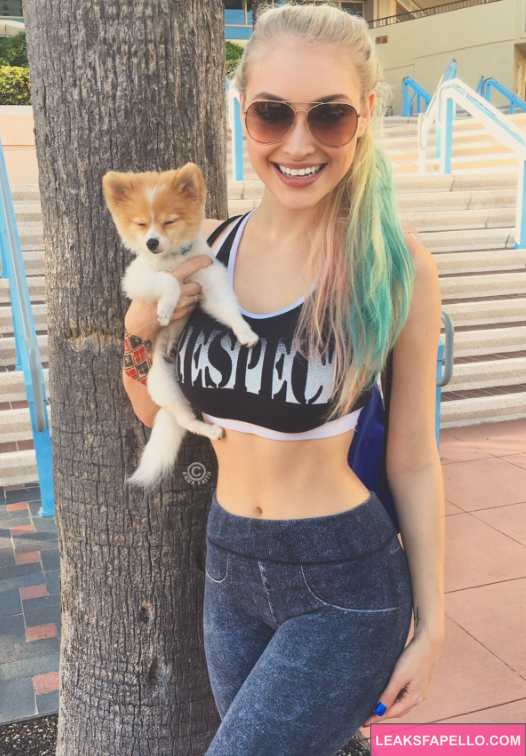 Anna Faith holding a cute cat and taking pic outdoors