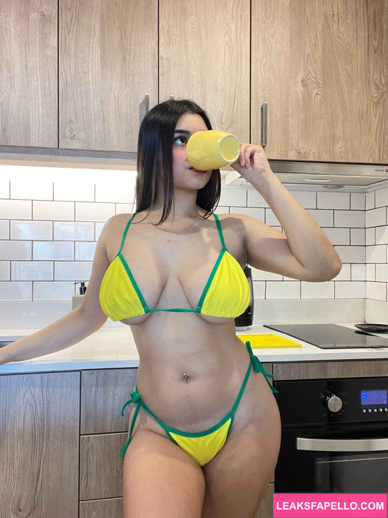 Angelina @sweetie.angelina OnlyFans big tits thick ass sexy hot only fan model wearing yellow two piece bikini drinking on a mug