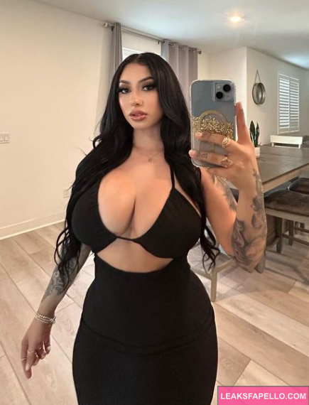 Maria Agredano takes mirror selfie wearing sexy black top and skirt in luxury dining room