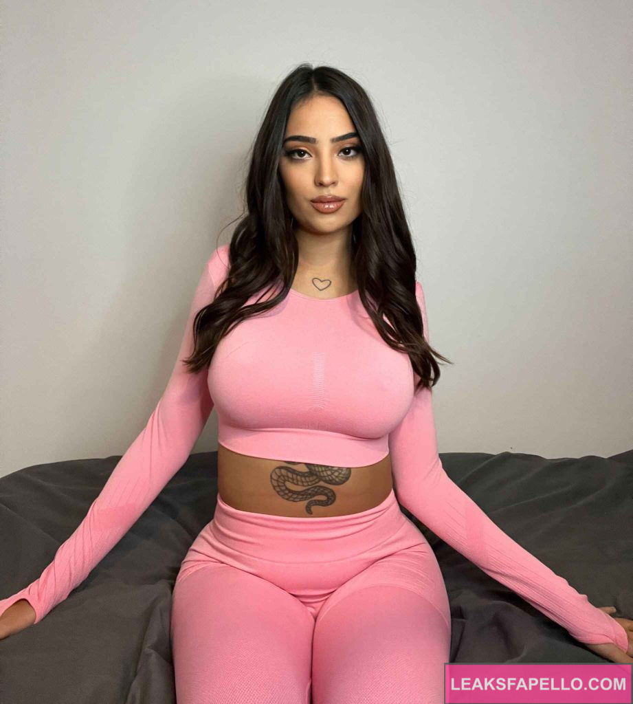 Sasha @sashaswan OnlyFans ig tits sexy brunette only fans hot model wearing pink long sleeves and pants sitting on the bed