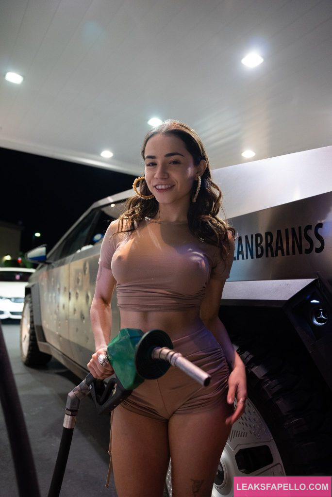 Jameliz @jamelizzzz OnlyFans hot big tits sexy only fans model wearing brown cropped shirt and shorts holding a gasoline pump