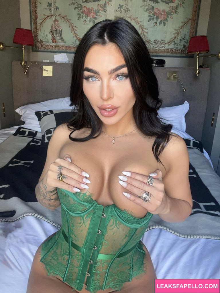 Emily Rinaudo @emjayplays OnlyFans big tits gorgeous hot thick only fans model wearing green lingerie sitting on the bed holding her tits