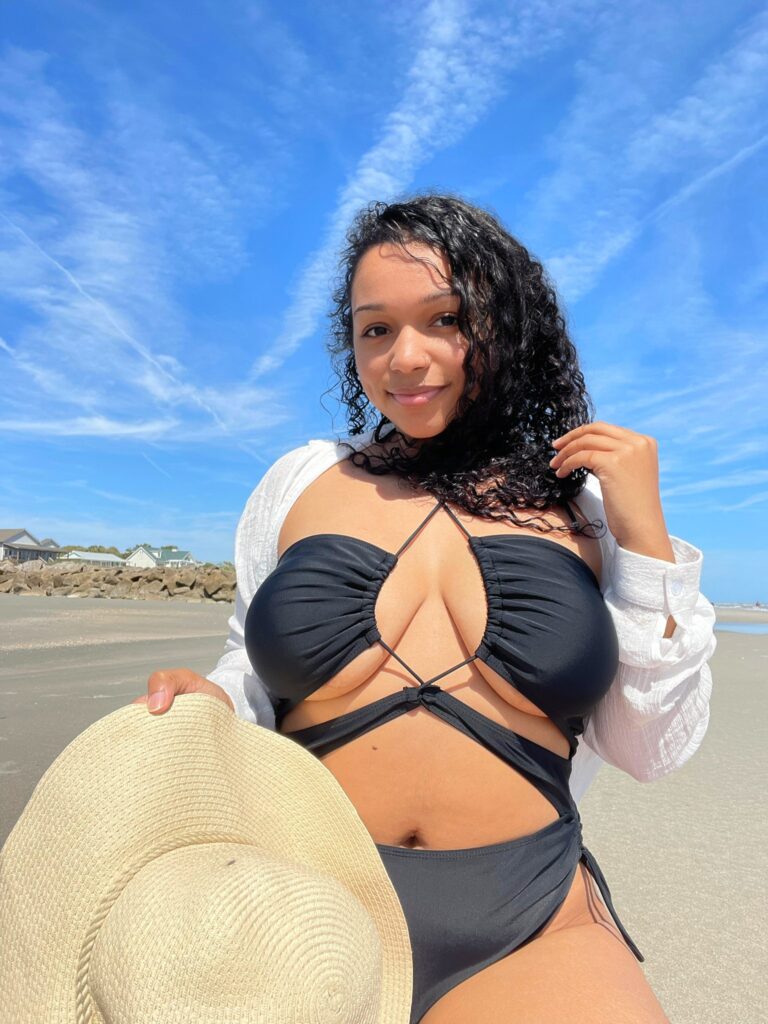 Jasmine @jasminelovve OnlyFans chubby hairy big boobs busty only fans model wearing black bikini on sand at the beach