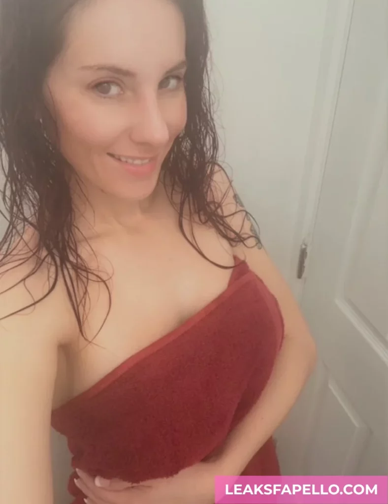 Kelly Caprice, Busty Readhead Tattooed MILF OnlyFans model, just got out from bathe, maroon towel wrapped on her body