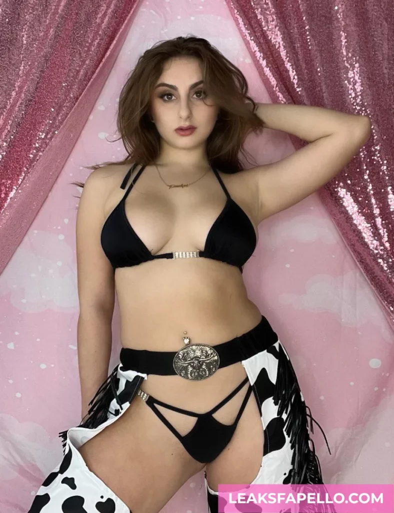 Penelope Kay, curvy brunette big tits OnlyFans model, in sexy cowgirl outfit