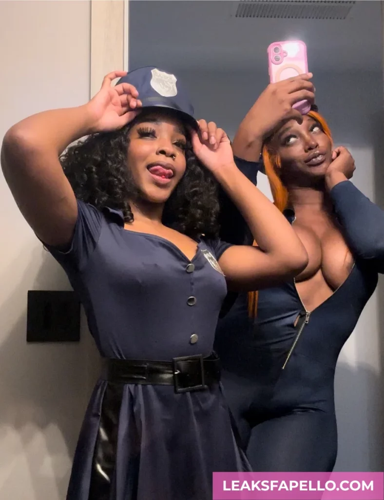 Angel Ace Pierce, ebony tattooed OnlyFans model, wearing a sexy police outfit, together with her friend