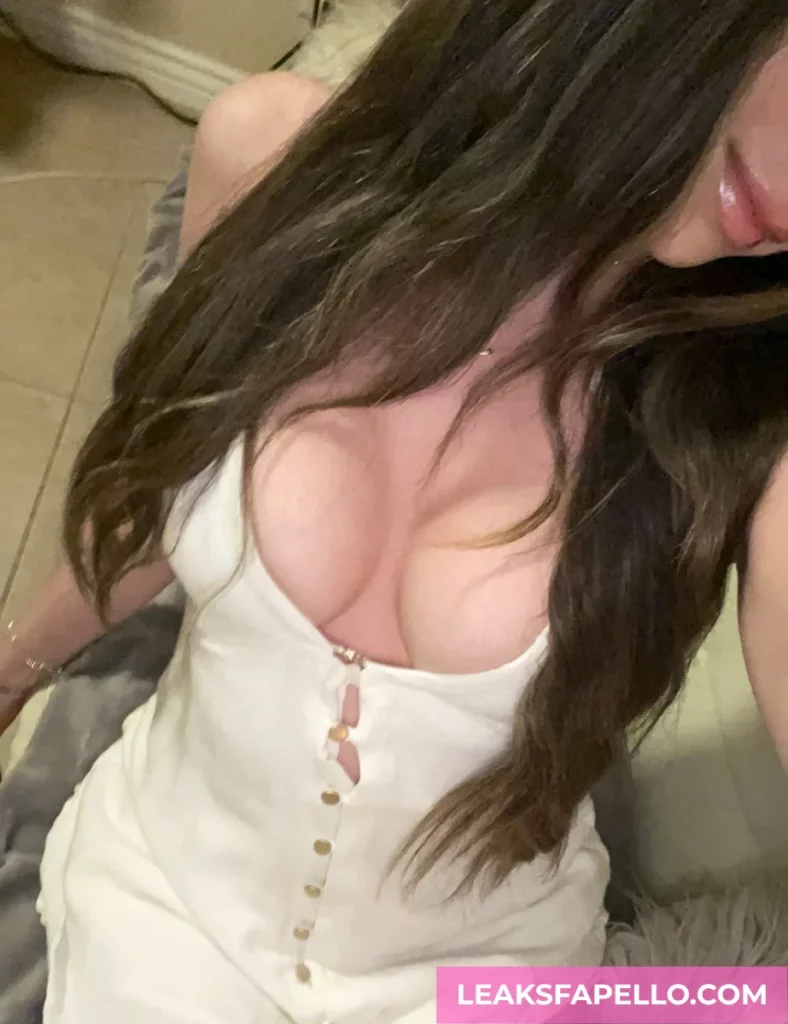Nina North, Curvy Big Tits Brunette OnlyFans model, is wearing a white dress