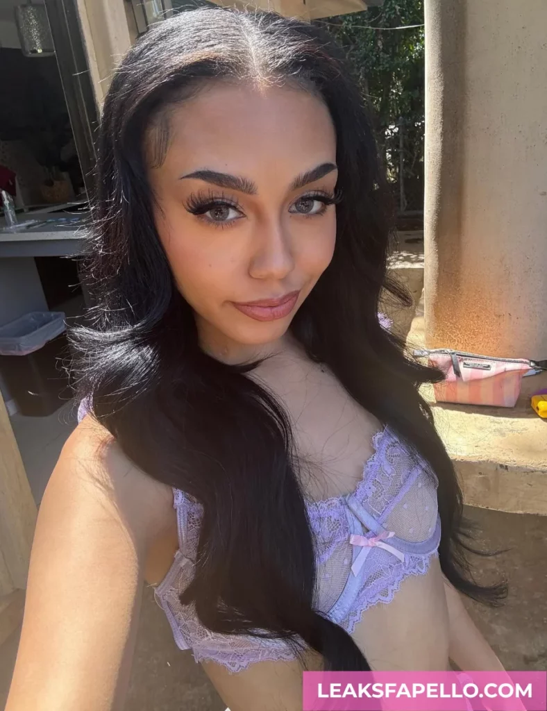 Bianca Bangs, Petite Big Ass Tattooed OnlyFans model, is wearing purple lingerie