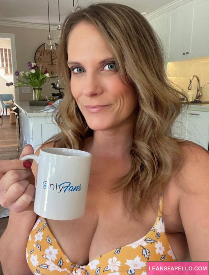 Annabelle Peaches drinking a cup of coffee with OnlyFans imprinted cup