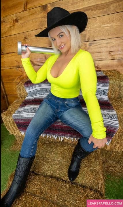 Sam Zee dressed like a cowboy, holding a hitch pin