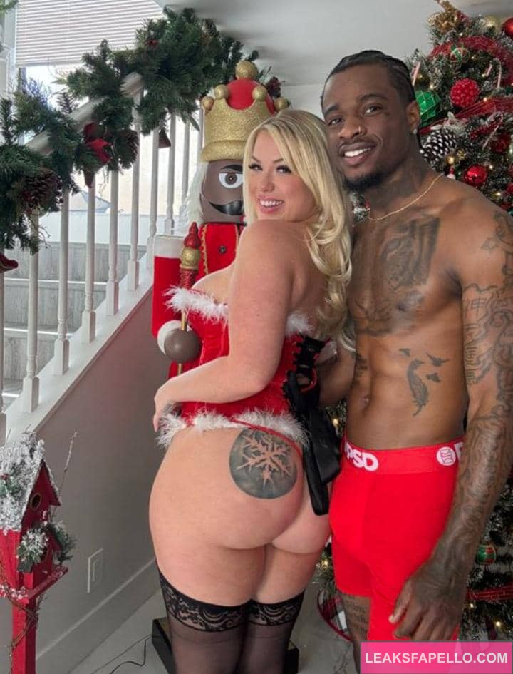 Becky Crocker and Damion Dayski beside the Christmas tree