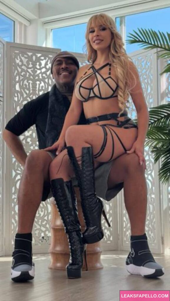 Carmen Caliente sitting on Dredds thighs