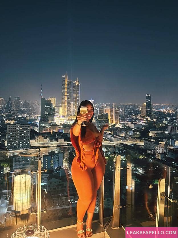 Candy Mary drinking over a beautiful scenic view